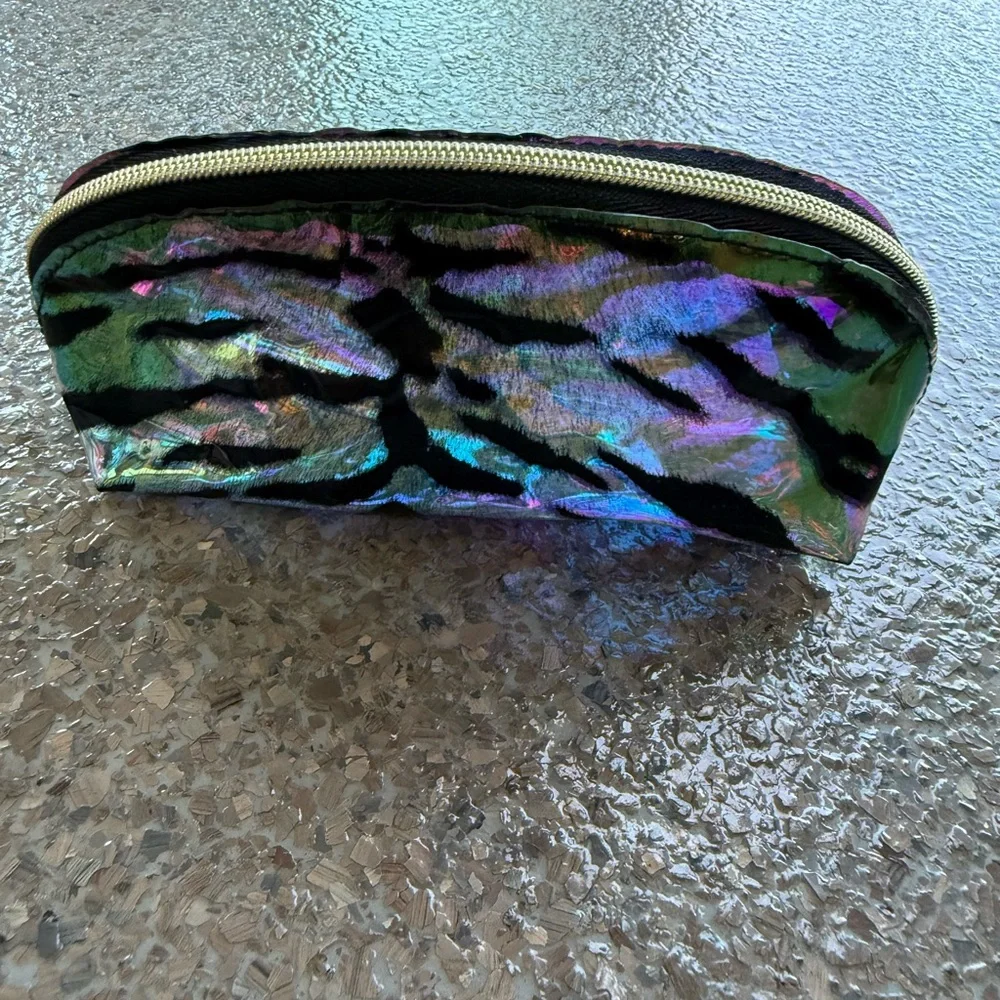 A iridescent zebra striped makeup bag
